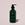 Green bottle of Acure hand wash on a beige background